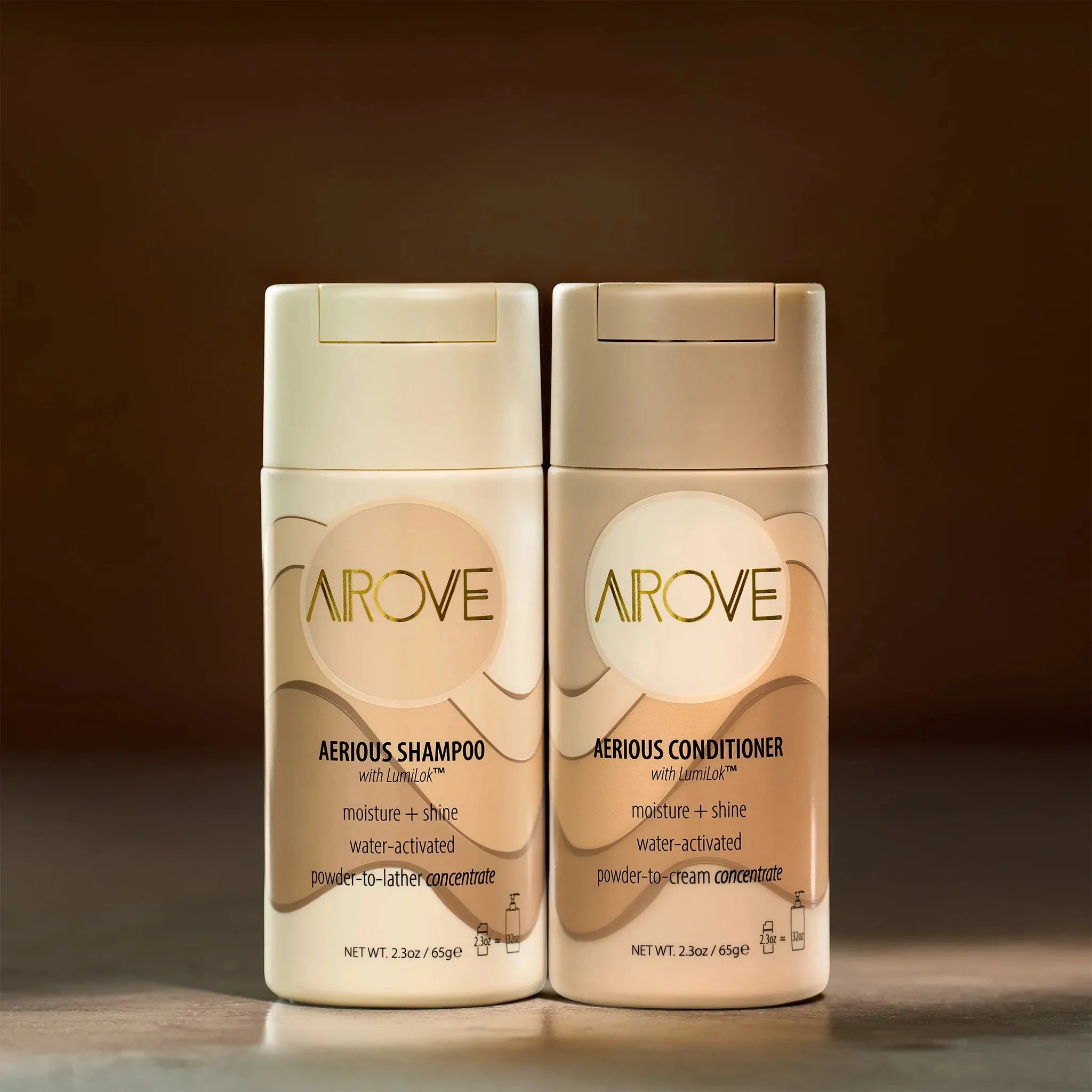 Front view of Arove Beauty Aerious Shampoo and Aerious Conditioner bottles on a warm background, highlighting waterless powder-to-lather and powder-to-cream sustainable haircare formulas.