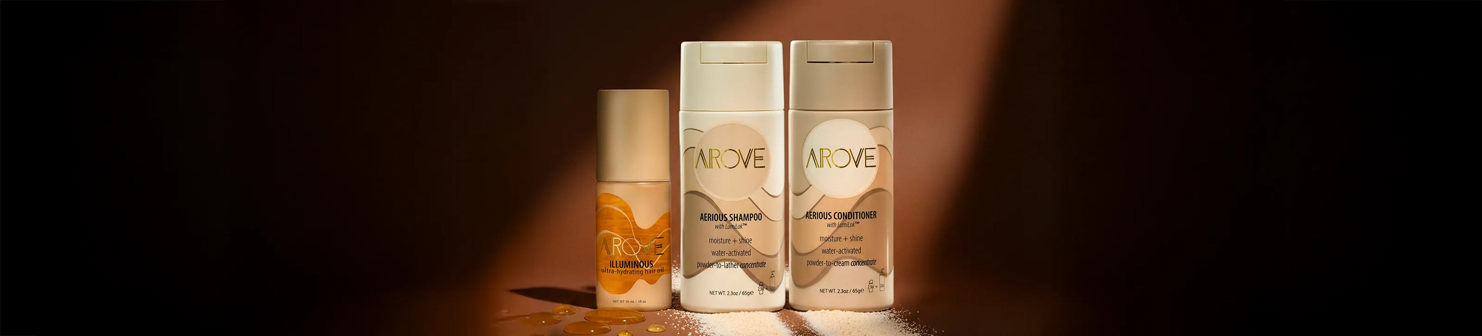 AROVE Signature Set with encapsulated water activated powder shampoo, conditioner and Illuminous hair oil on a warm sand background