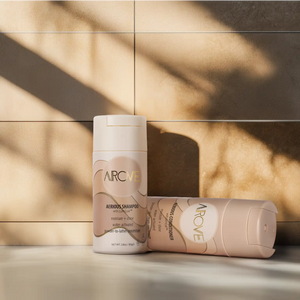 A sleek, minimalist display of AROVE’s powder-to-lather shampoo and conditioner, designed for eco-conscious beauty lovers.