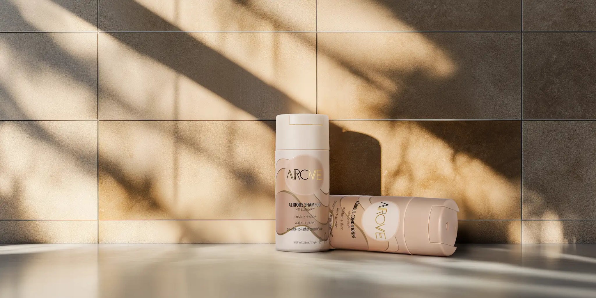 AROVE Shampoo and Conditioner displayed against a sleek, tiled backdrop, emphasizing its modern, high-performance formulation.